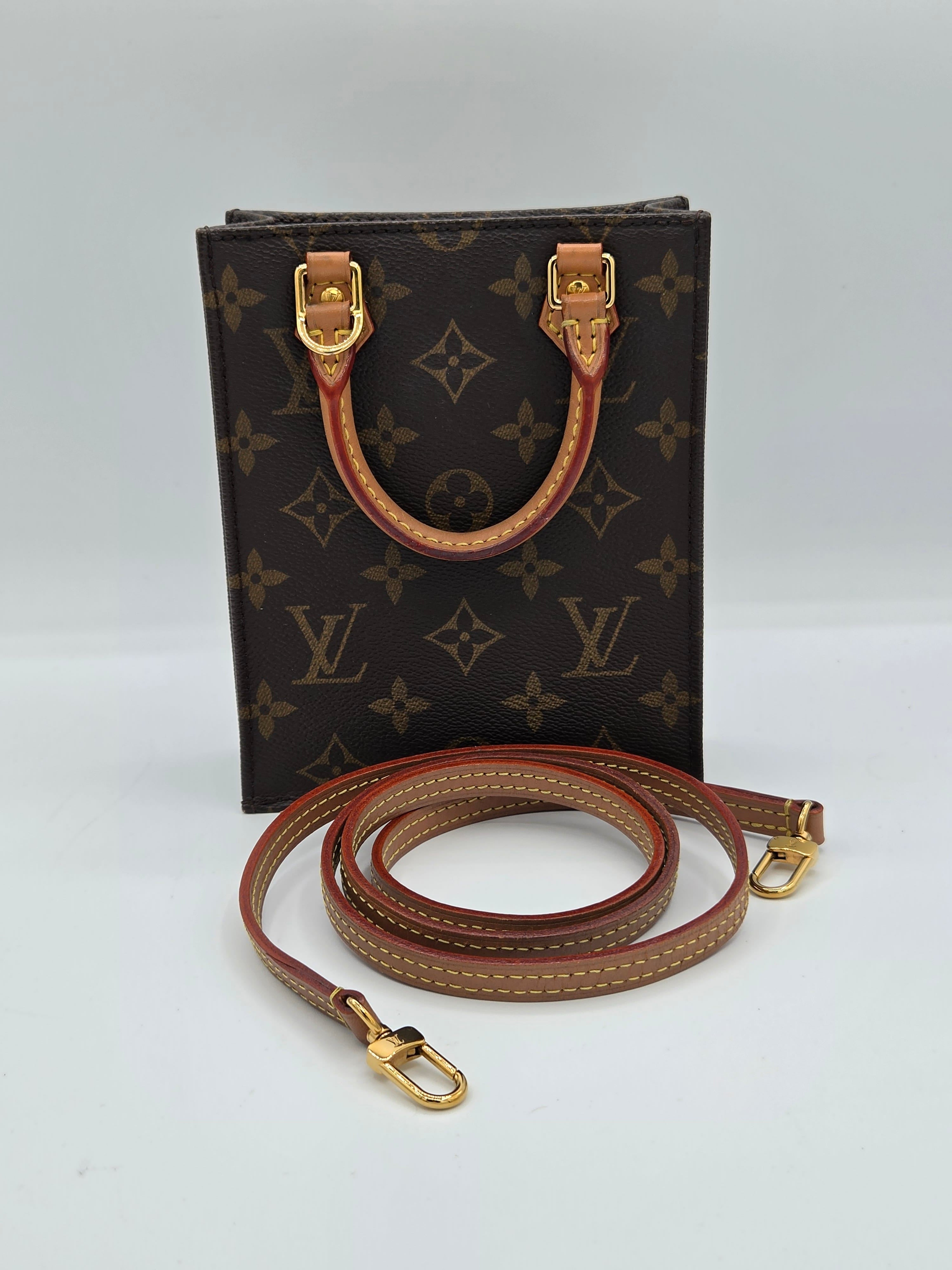 Louis Vuitton monogram canvas shoulder bag with brown leather strap and gold-tone hardware, photographed on a plain light background.
