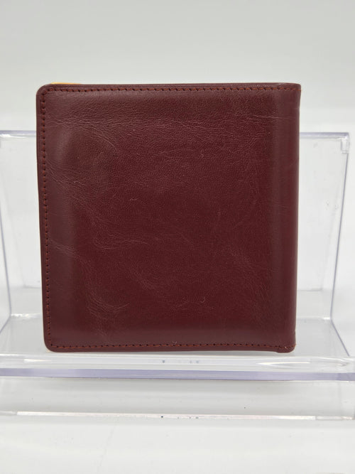 A dark brown leather bifold wallet displayed inside a clear acrylic block against a white background.
