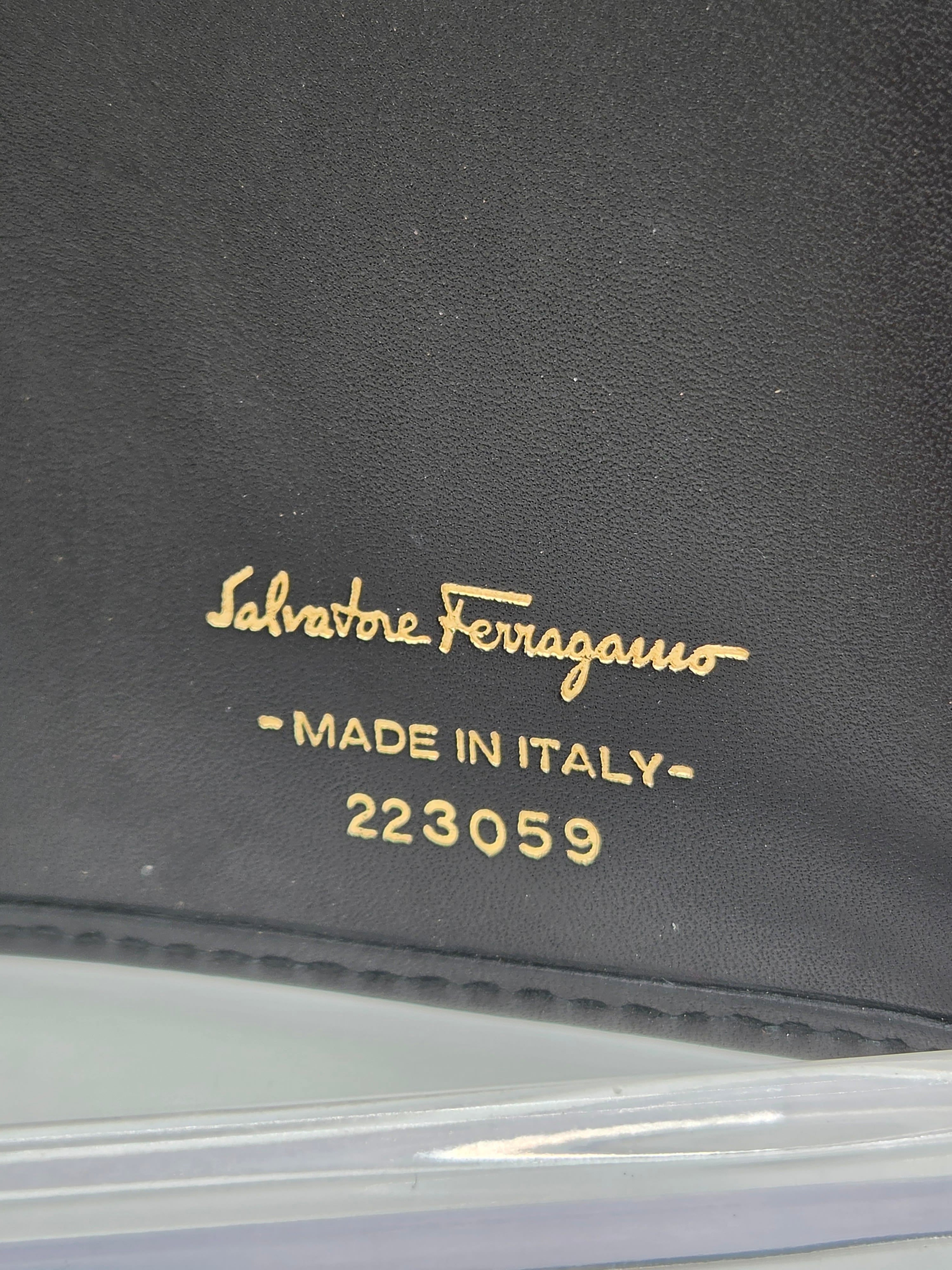 Close-up of a black leather item with gold embossed text reading 'Sabaioe Salvatore' and 'MADE IN ITALY 223059'.