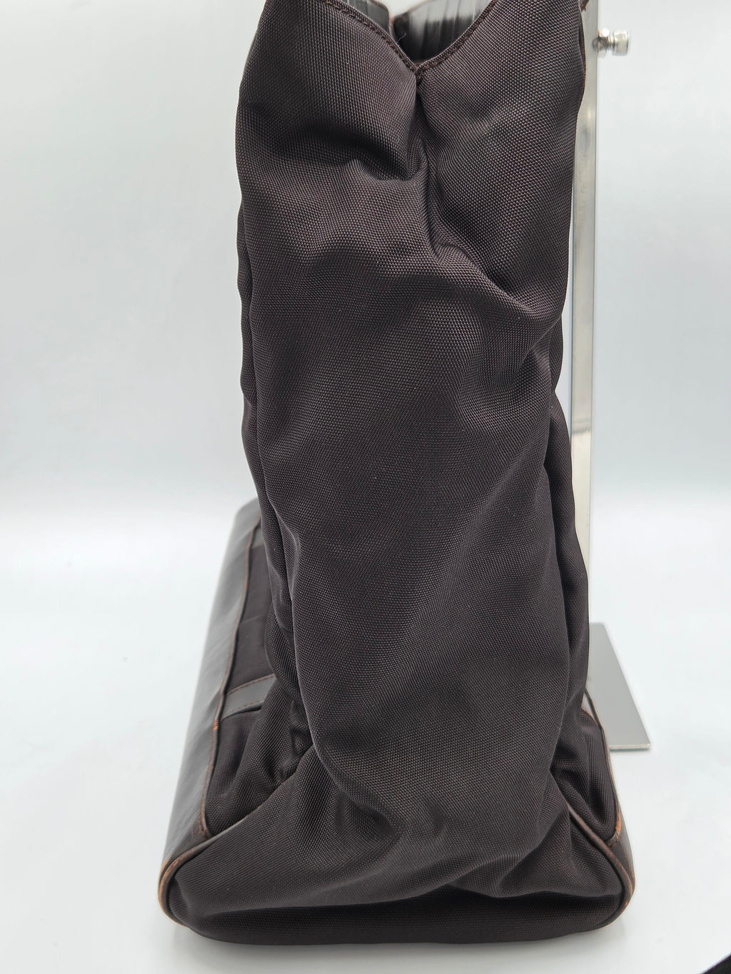 A dark brown fabric-covered boot or shoe shown from an angled side view against a plain white background.