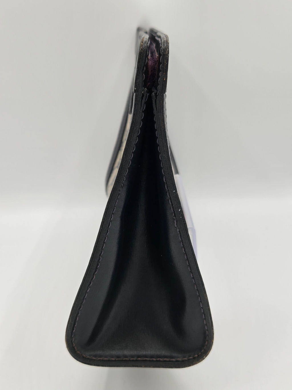 A black leather or faux-leather strap accessory with stitched edges, shown against a plain white background.