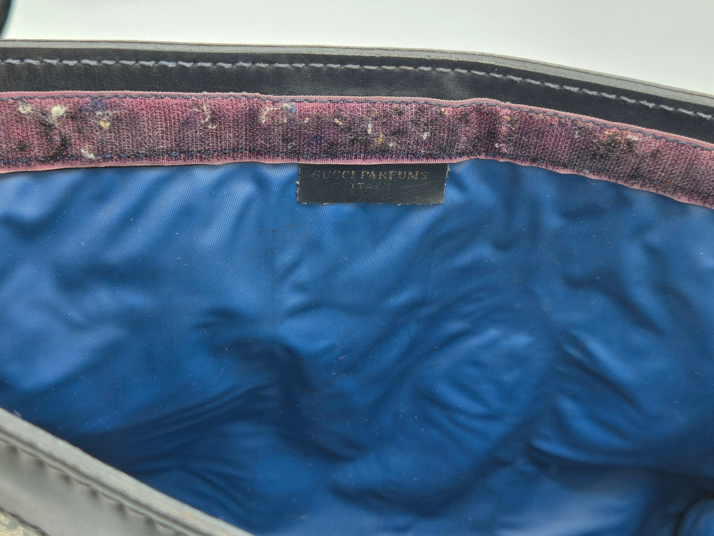 Close-up of the interior of a Gucci bag, showing a vibrant blue satin lining, a dusty mauve velvet trim, and a black Gucci Parfums label.
