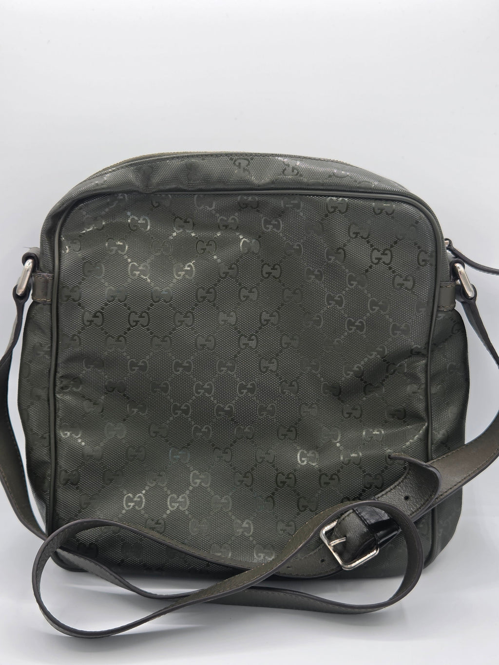 A dark olive green Gucci shoulder bag with the brand's signature GG monogram pattern, featuring a black leather strap with a silver buckle, photographed against a plain white background.
