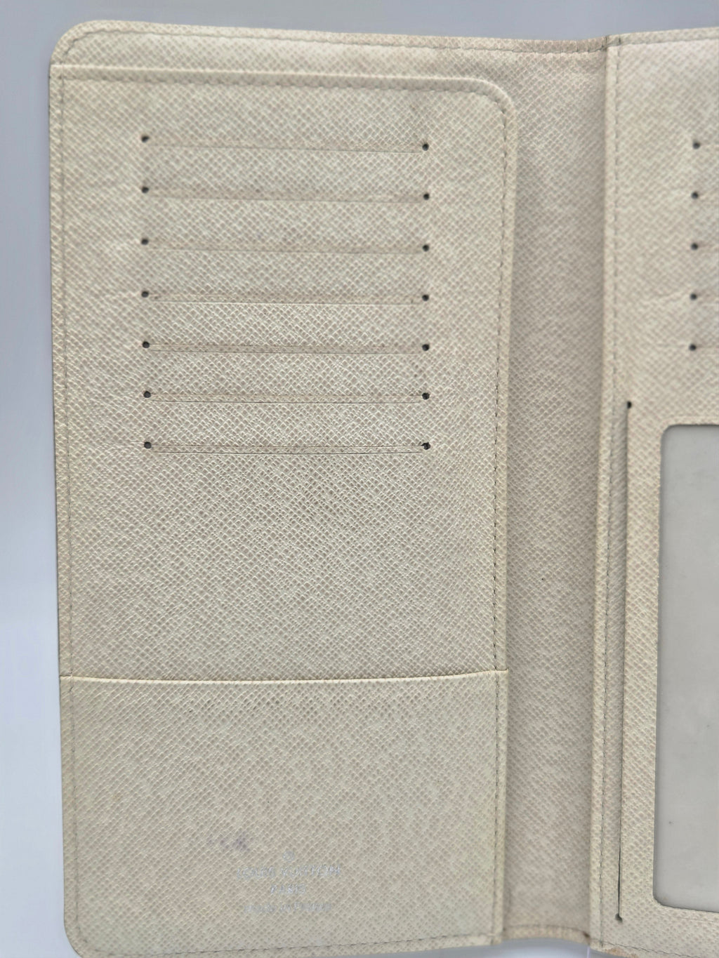 Beige textured faux-leather wallet cover shown open, displaying interior card slots on the left and an ID window on the right.