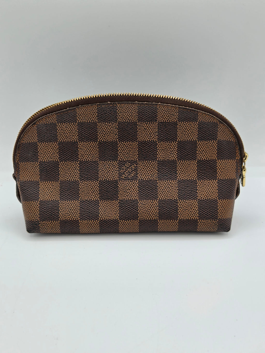 A Louis Vuitton zippered pouch in the brand's signature Damier Ebene checkerboard canvas, featuring a small embossed LV logo on the front, set against a plain light gray background.