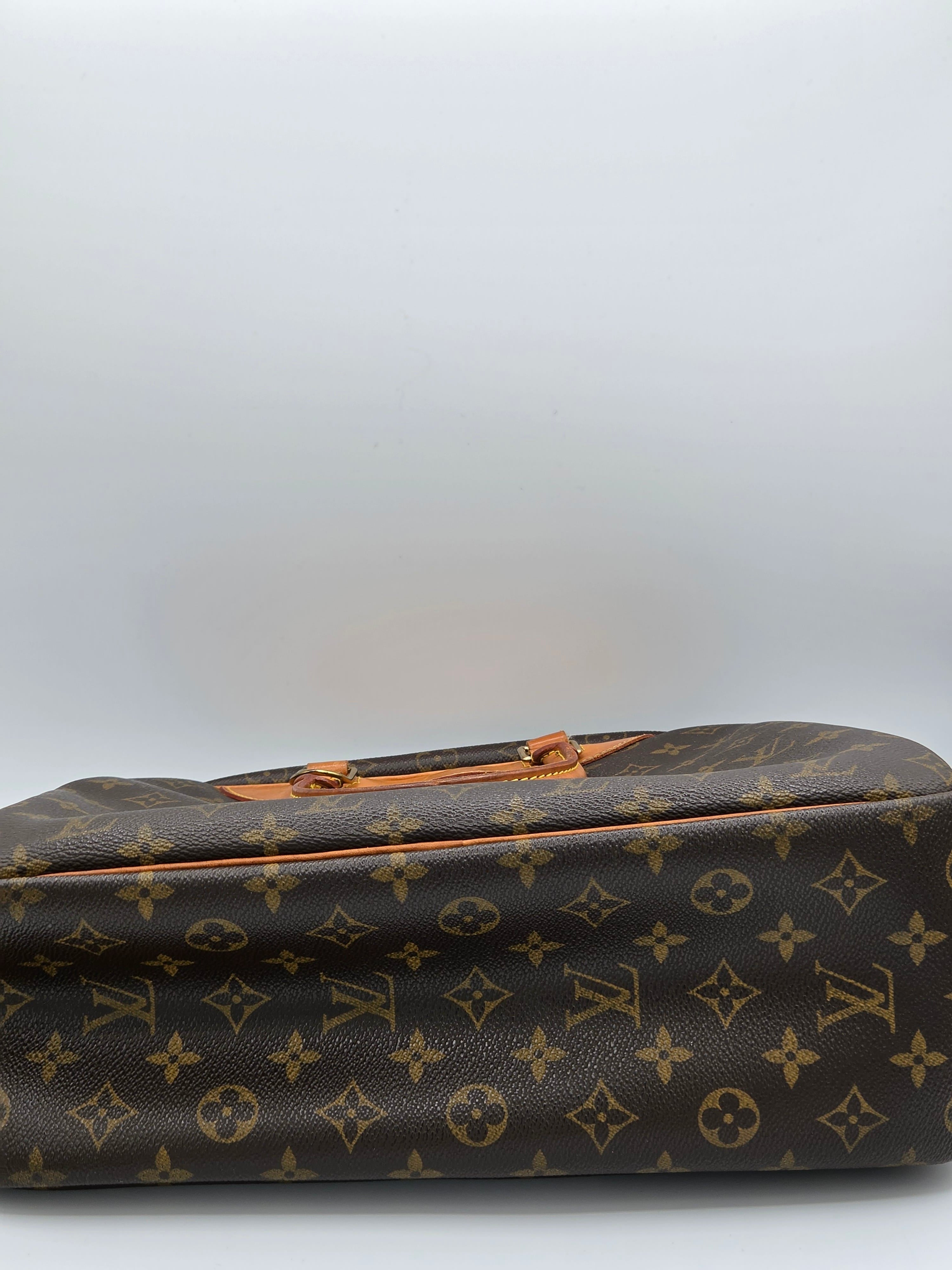 Louis Vuitton monogram canvas bag in brown and tan, shown cropped on the right side against a plain light gray background.