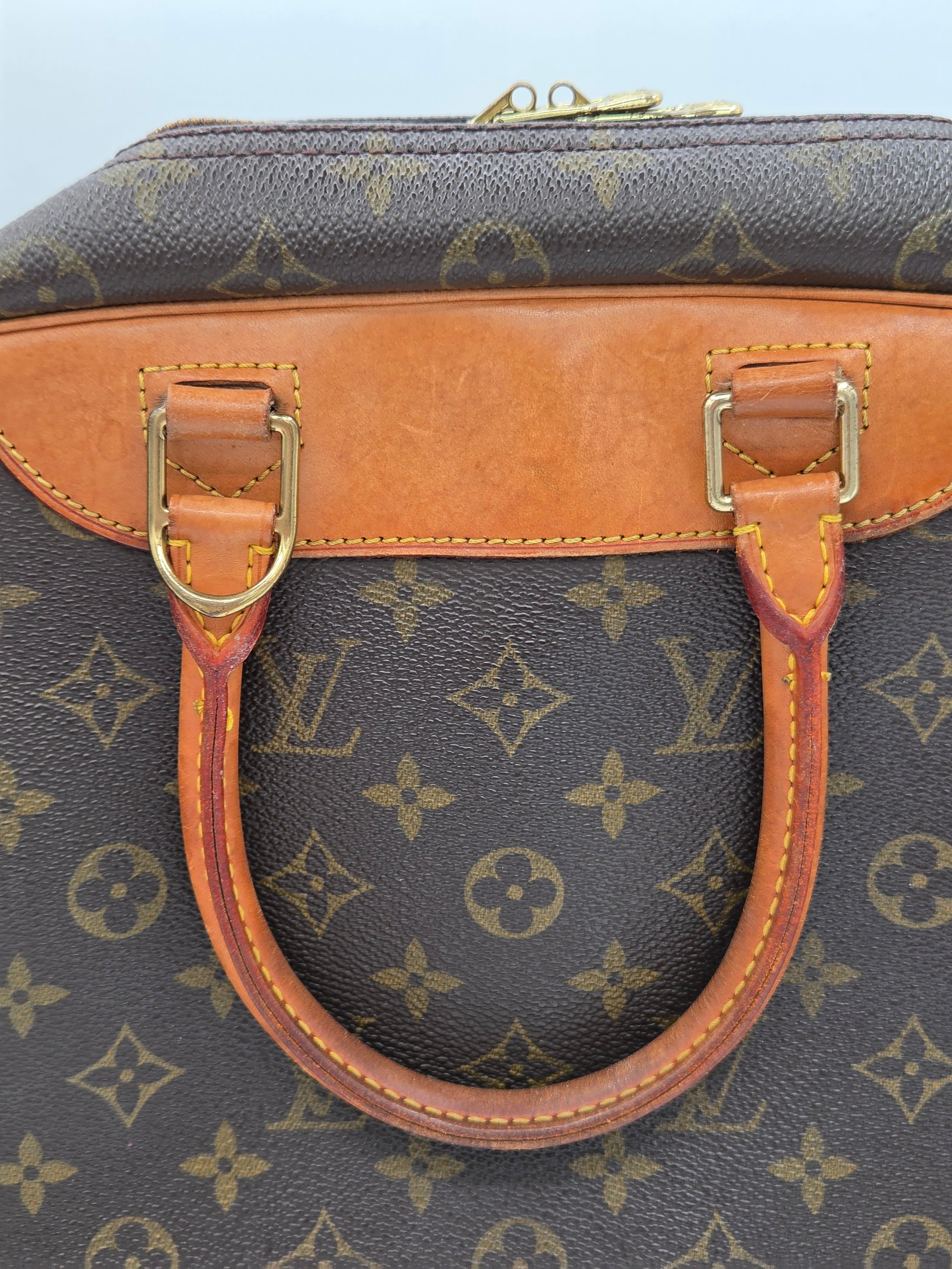 Close-up of a Louis Vuitton handbag in brown monogram canvas with tan leather trim and gold-tone hardware.