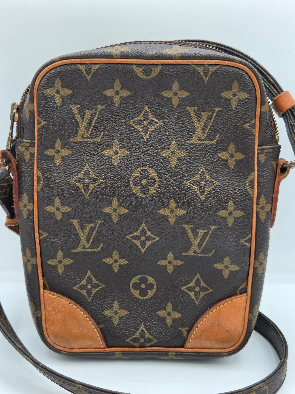 A Louis Vuitton monogram canvas shoulder bag in brown and tan, featuring the classic LV monogram pattern and tan leather corner patches, shown against a plain light background.
