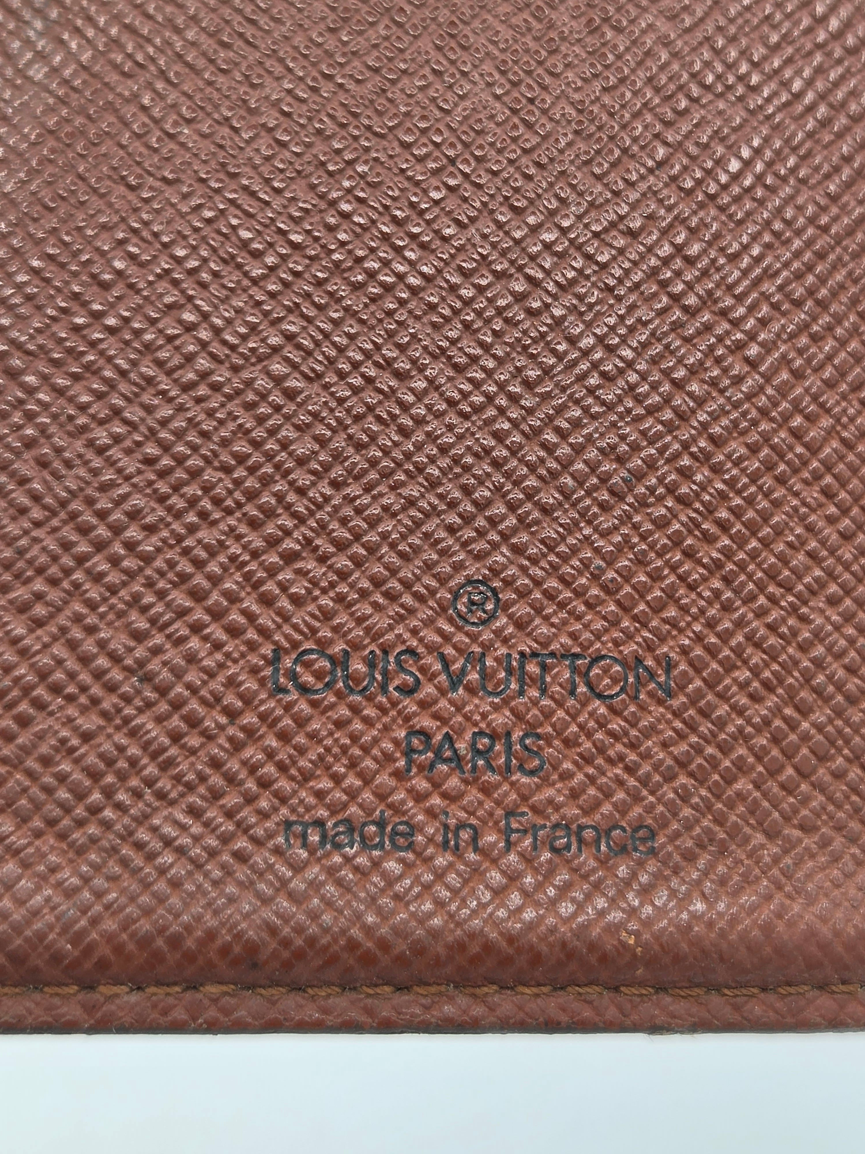 Close-up of a brown Louis Vuitton textured leather surface with embossed branding reading 'LOUIS VUITTON PARIS made in France'.