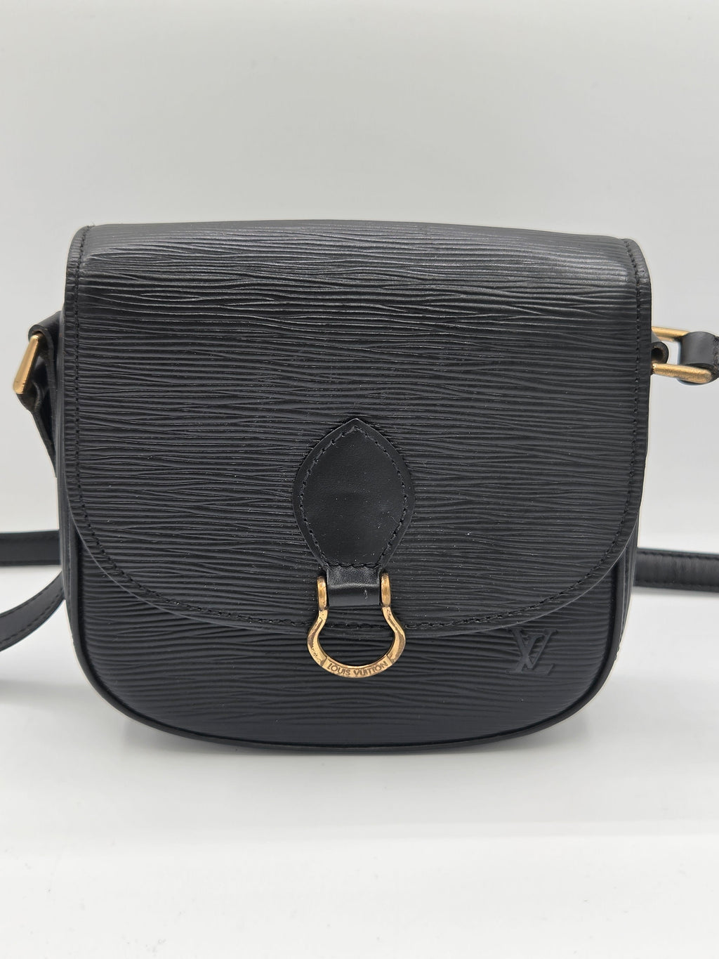 A black textured leather shoulder bag with a gold-tone horsebit hardware accent on the front flap, shown against a plain white background.