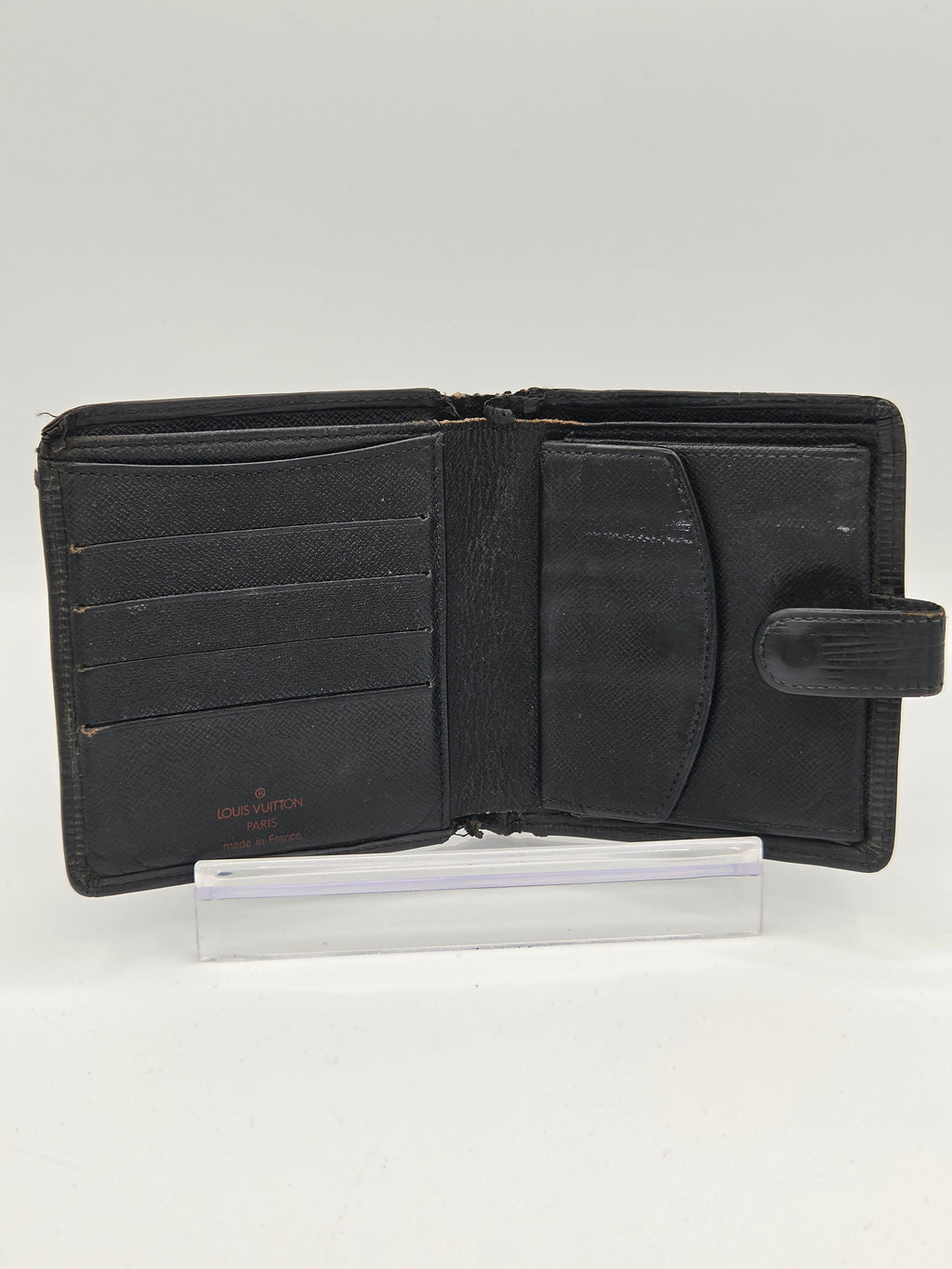 An open black leather wallet with multiple card slots and a vertical pocket, shown against a plain white background.