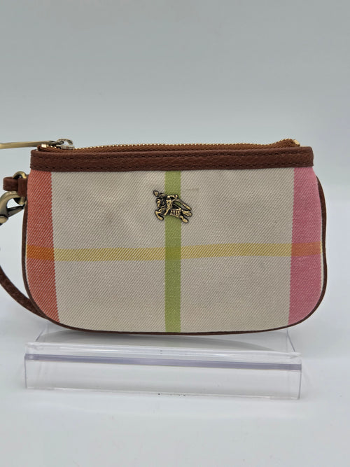 A small zip-around wristlet clutch with a beige plaid pattern, pink and green stripes, brown trim, and a gold-tone horse logo charm, shown next to a clear plastic display block.