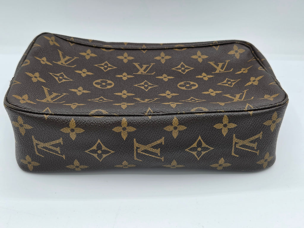 A Louis Vuitton monogram canvas pouch in dark brown and tan, photographed on a plain white background.