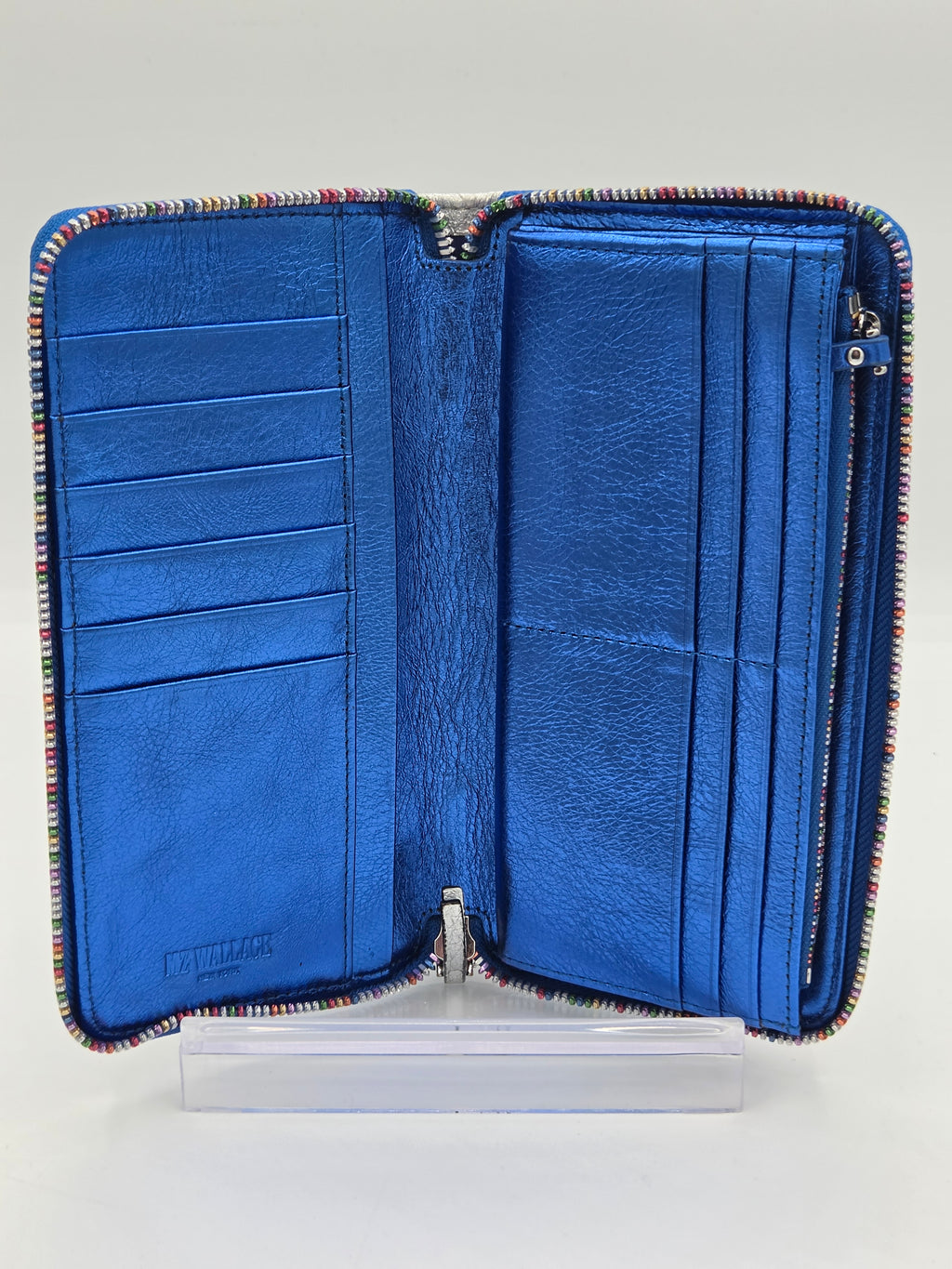 An open blue leather zip-around wallet with multiple card slots and a striped multicolor trim, displayed on a clear acrylic stand against a light gray background.