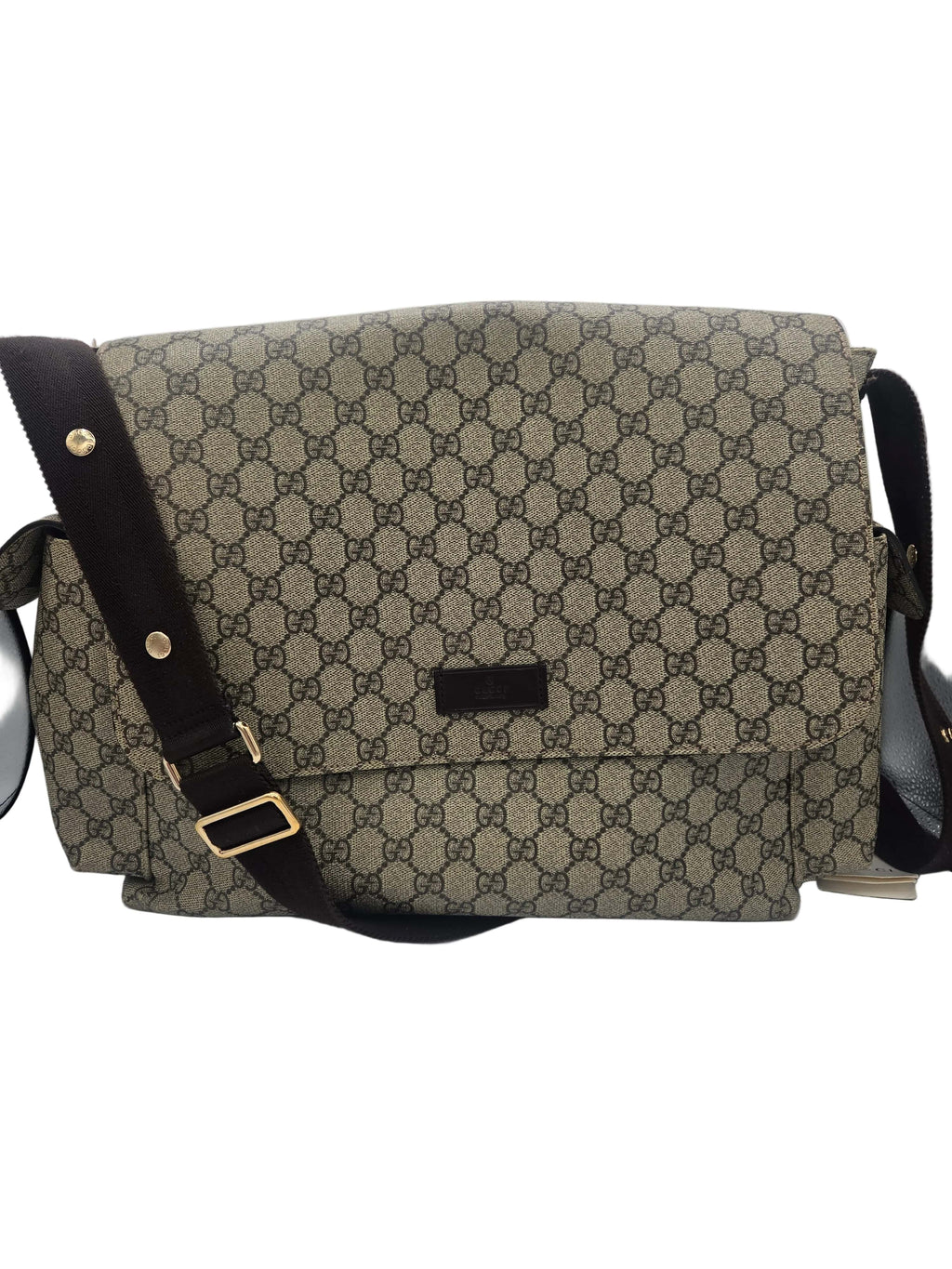 A vintage-style shoulder bag featuring the classic beige and brown GG monogram canvas, a dark brown leather strap with gold-tone hardware, and a small black leather brand plaque on the front flap.