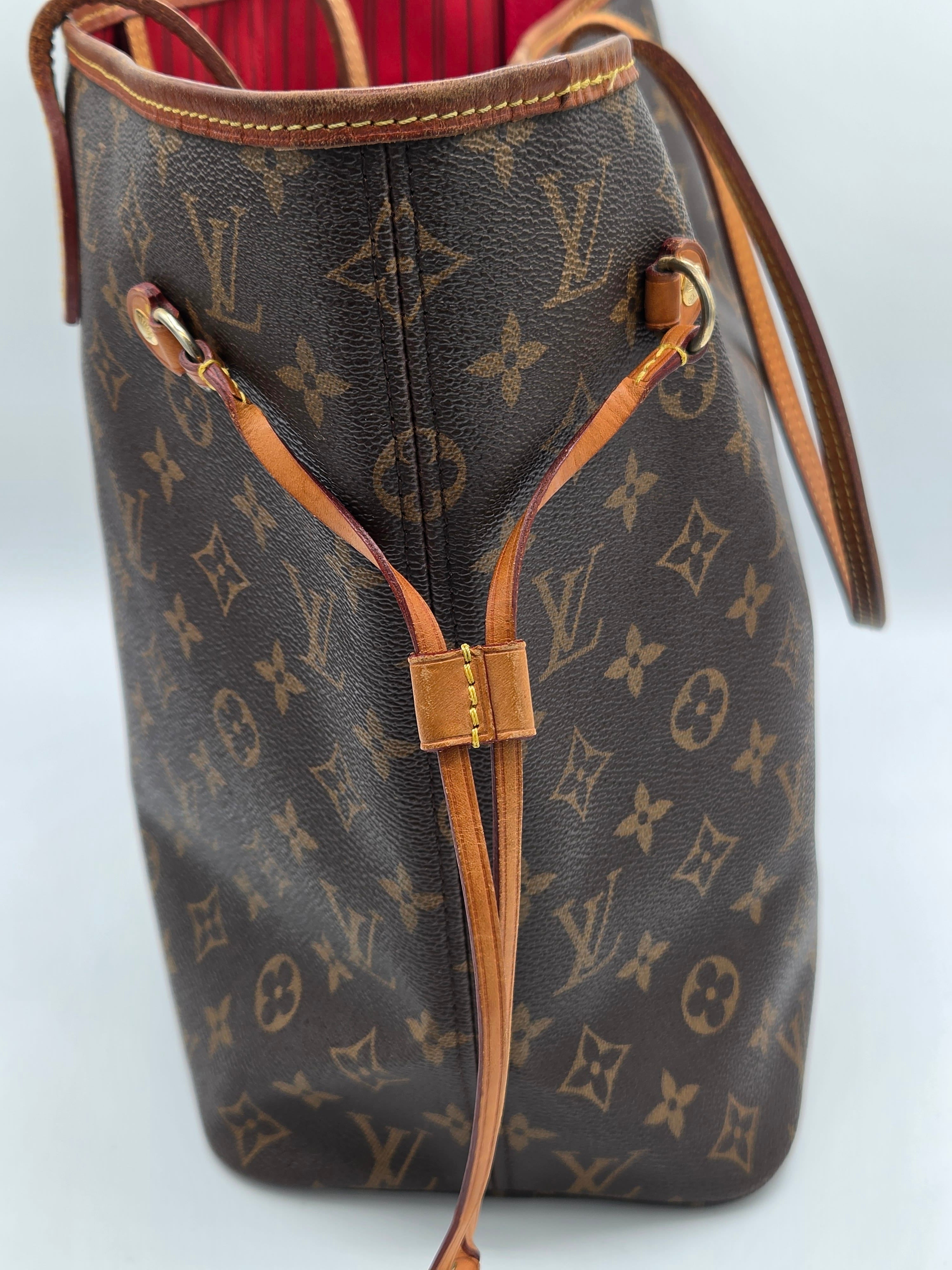 A Louis Vuitton monogram canvas tote bag with brown leather trim and drawstring details, shown against a light gray background.