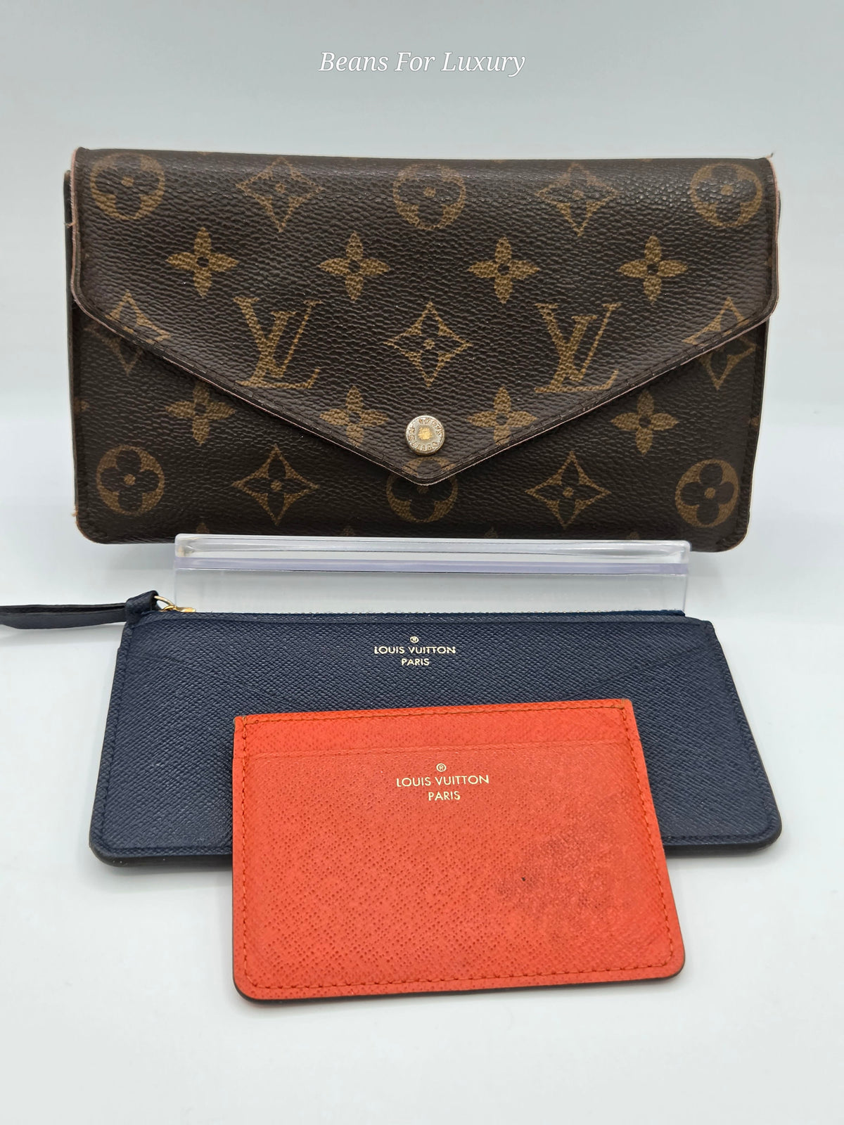 brown canvas wallet with orange card holder and blue zipper pouch