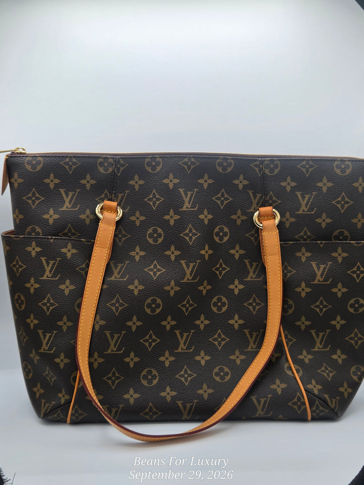 A Louis Vuitton monogram canvas tote bag with tan leather handles and gold-tone hardware, photographed against a white studio background with a black vignette at the corners.