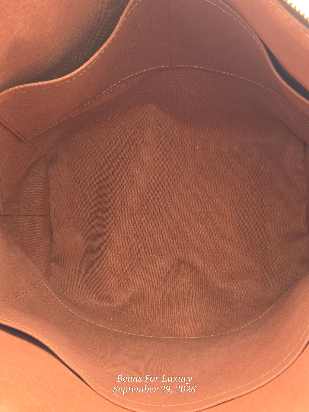 Close-up view of the interior lining of a brown leather or suede bag, showing the inside of a main compartment with a zipper closure at the top. White text at the bottom reads 'Beans For Luxury September 29, 2026'.
