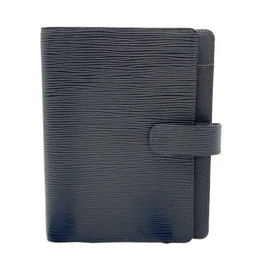 A black LOUIS VUITTON notebook cover made of epi leather, with a flap closure on the front.