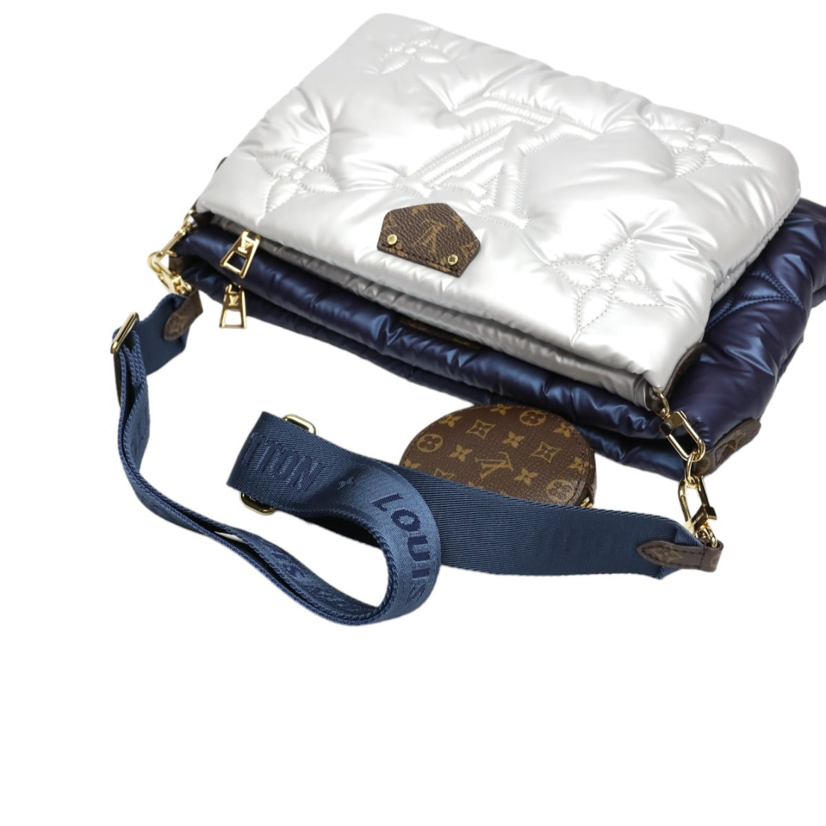 White quilted handbag with gold accents and a blue strap on a white background