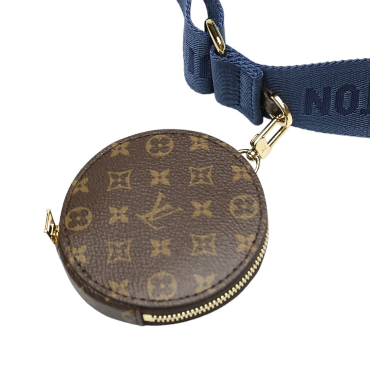 Round monogrammed purse with a blue strap on a white background