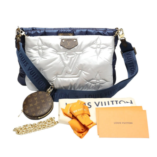 Louis Vuitton handbag with accessories on a white background