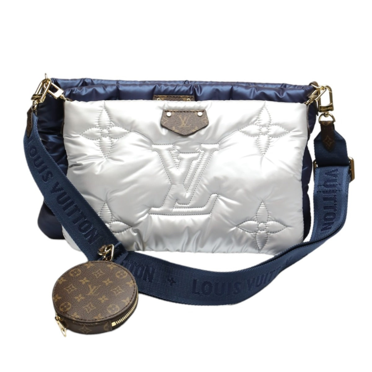 White quilted handbag with blue strap and gold hardware on a white background