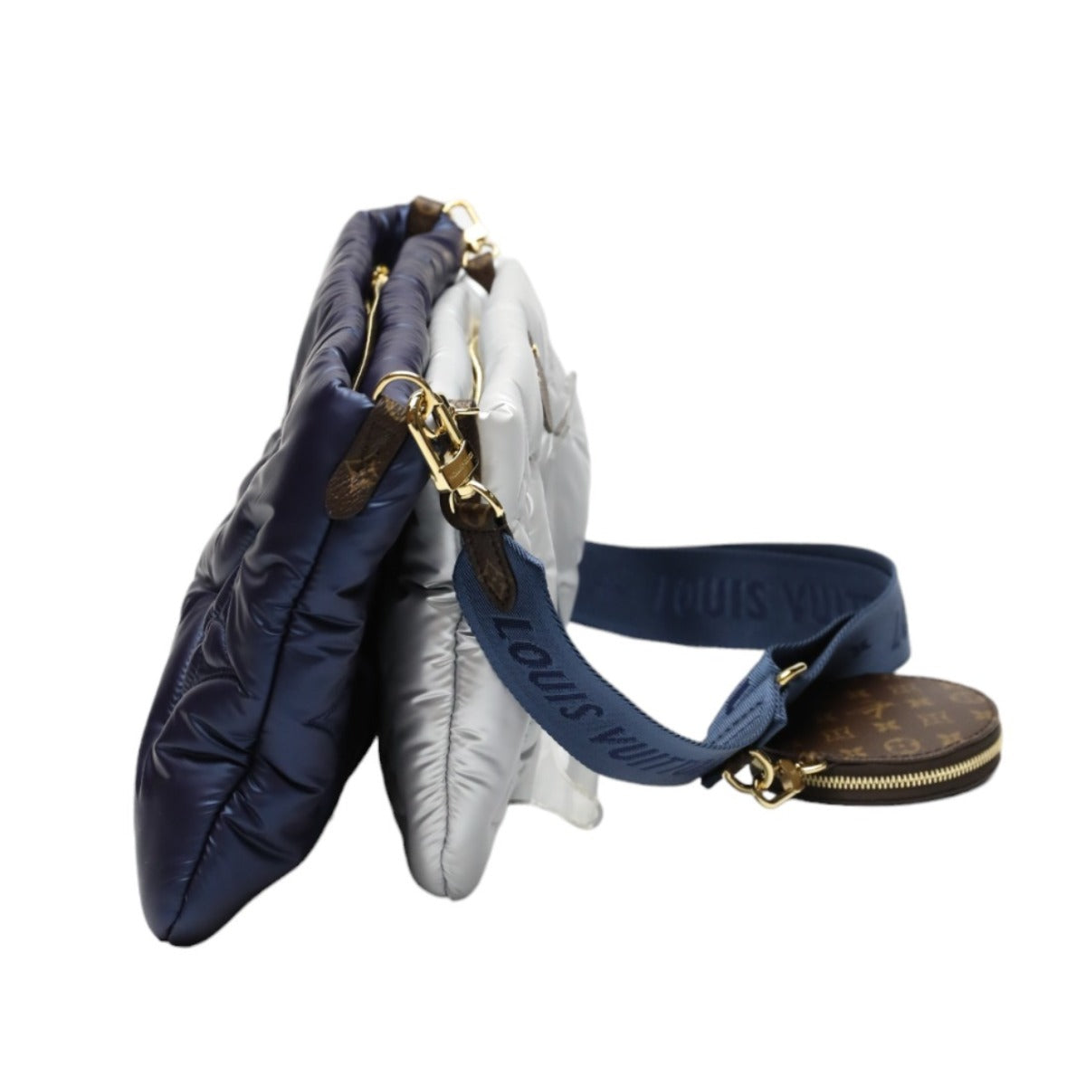Two Louis Vuitton handbags, one navy and one white, with a gold clasp on a white background.