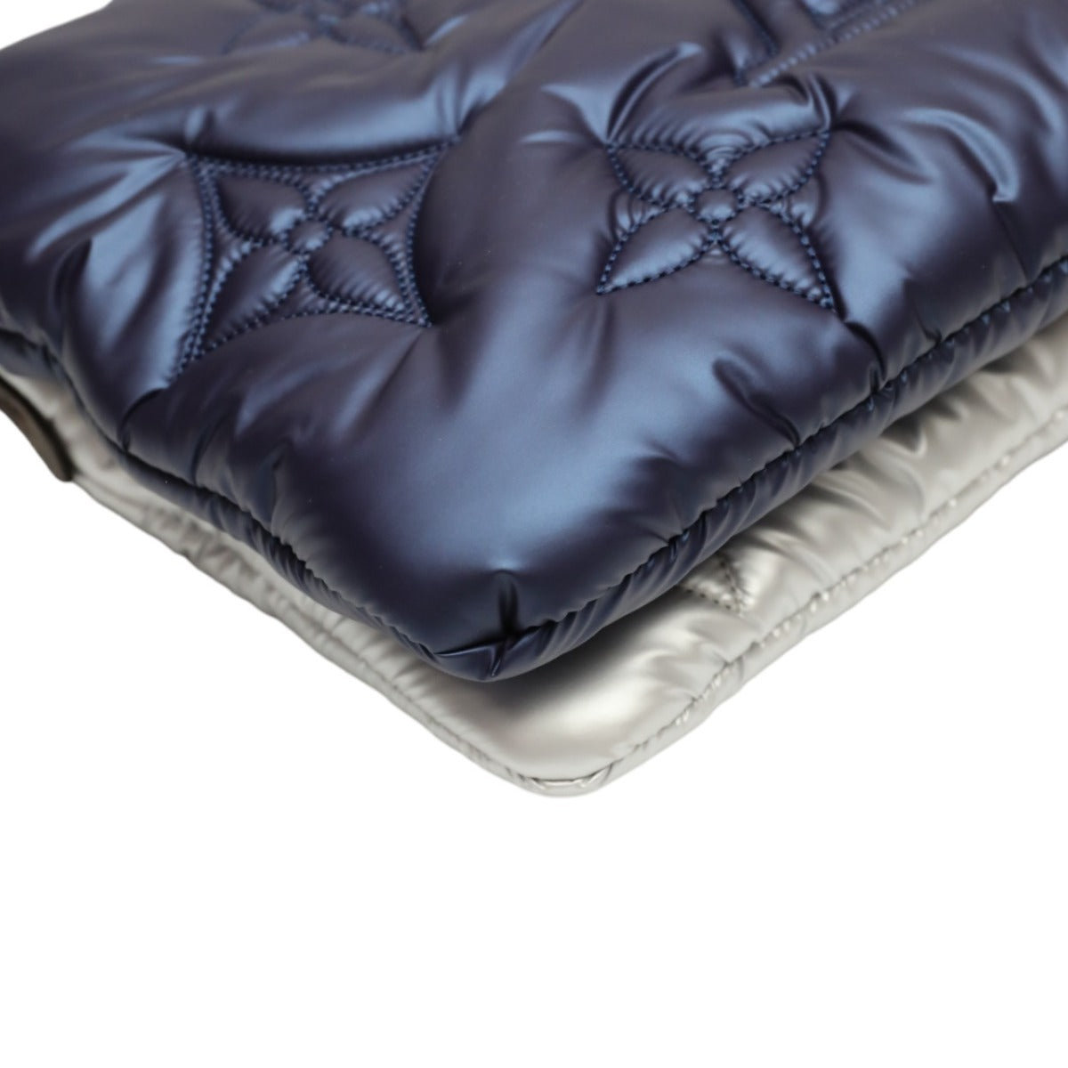 Close-up of a quilted blue and beige fabric on a white background