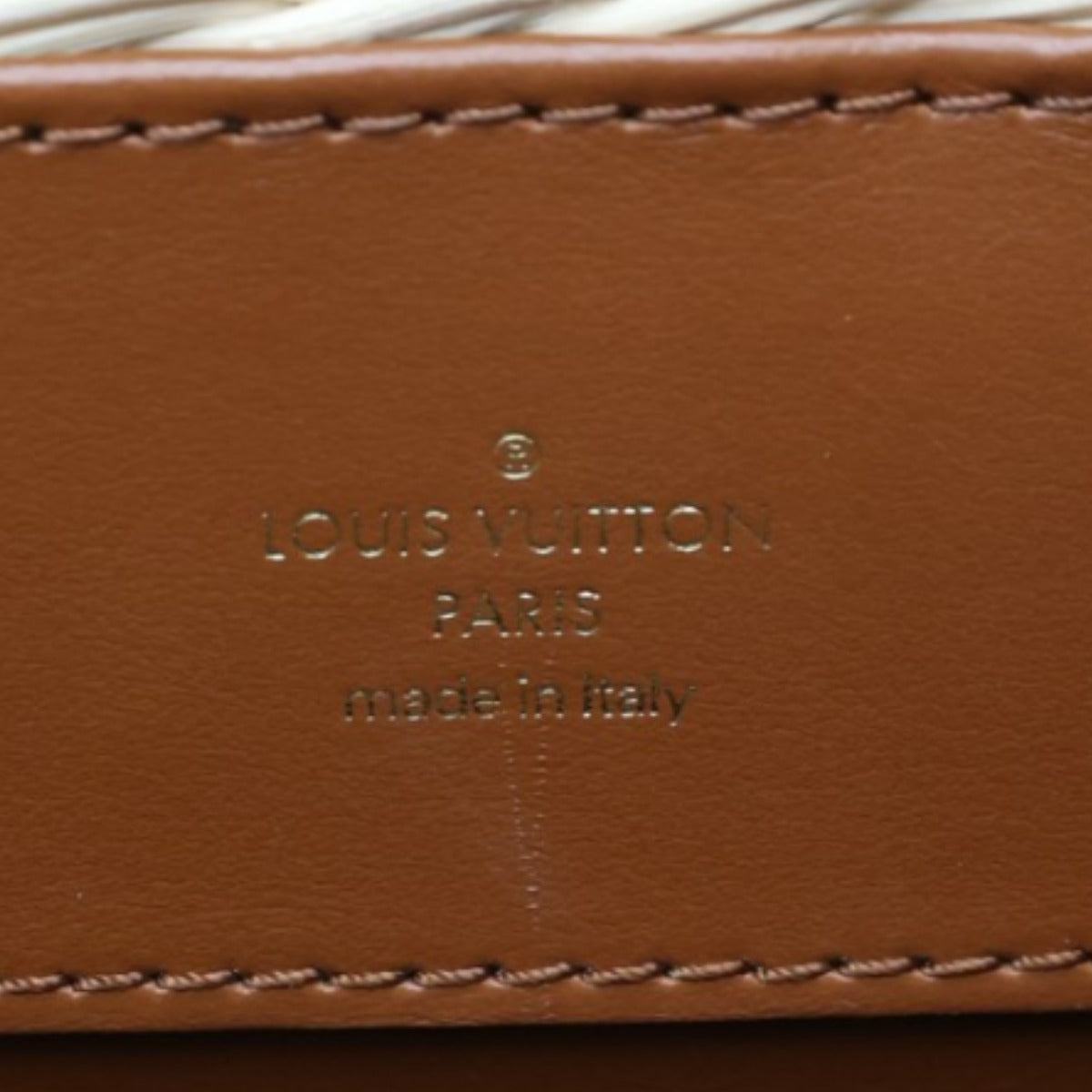 Close-up of a brown Louis Vuitton wallet with visible branding.