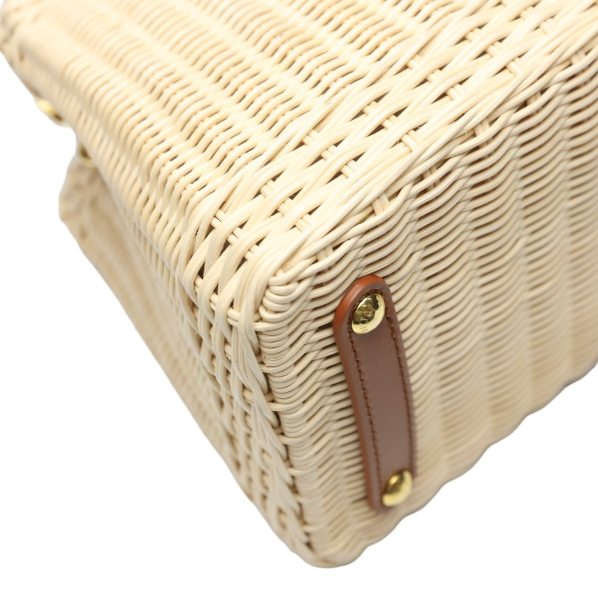 Close-up of a woven basket with a brown handle on a white background