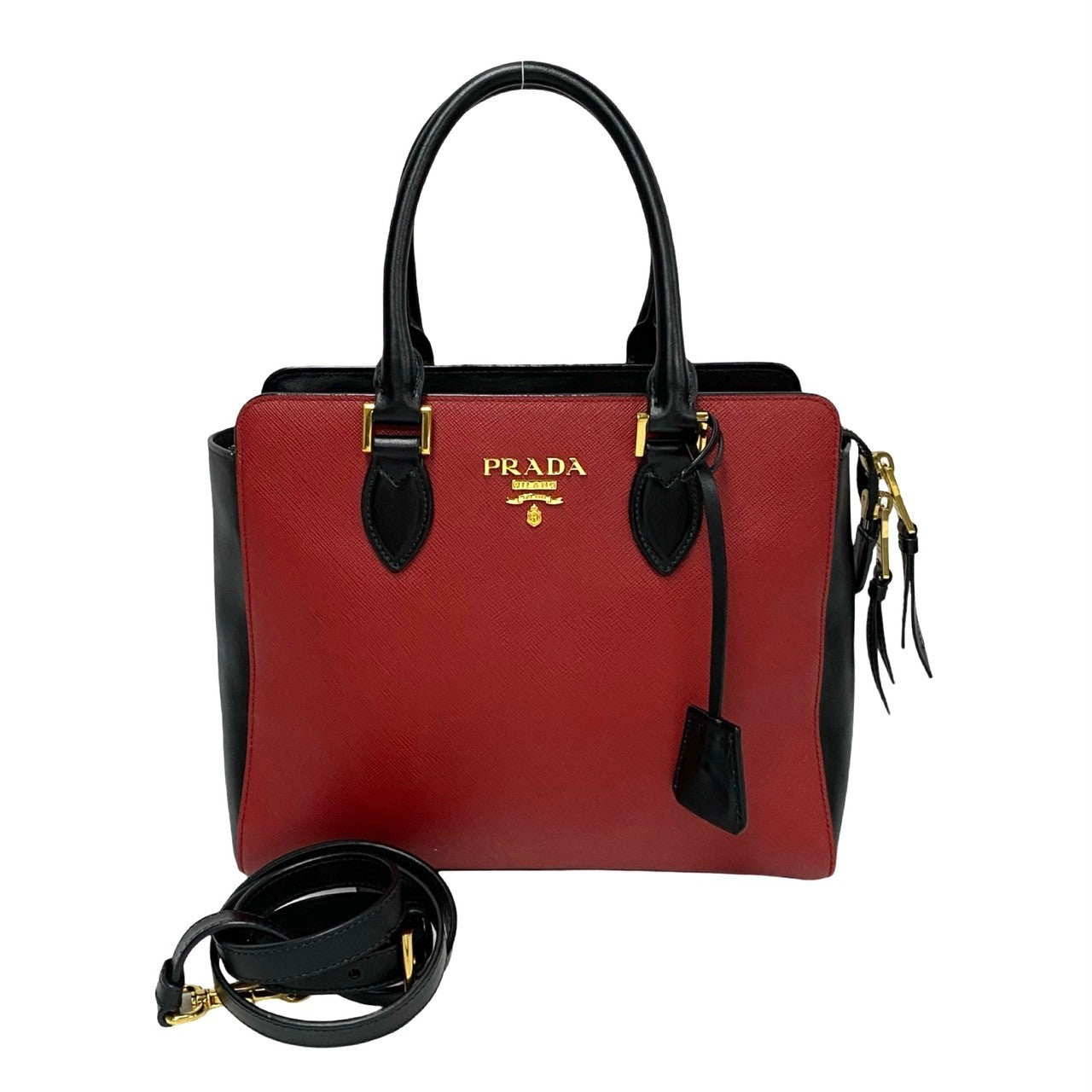 Red Prada handbag with black accents on a white background