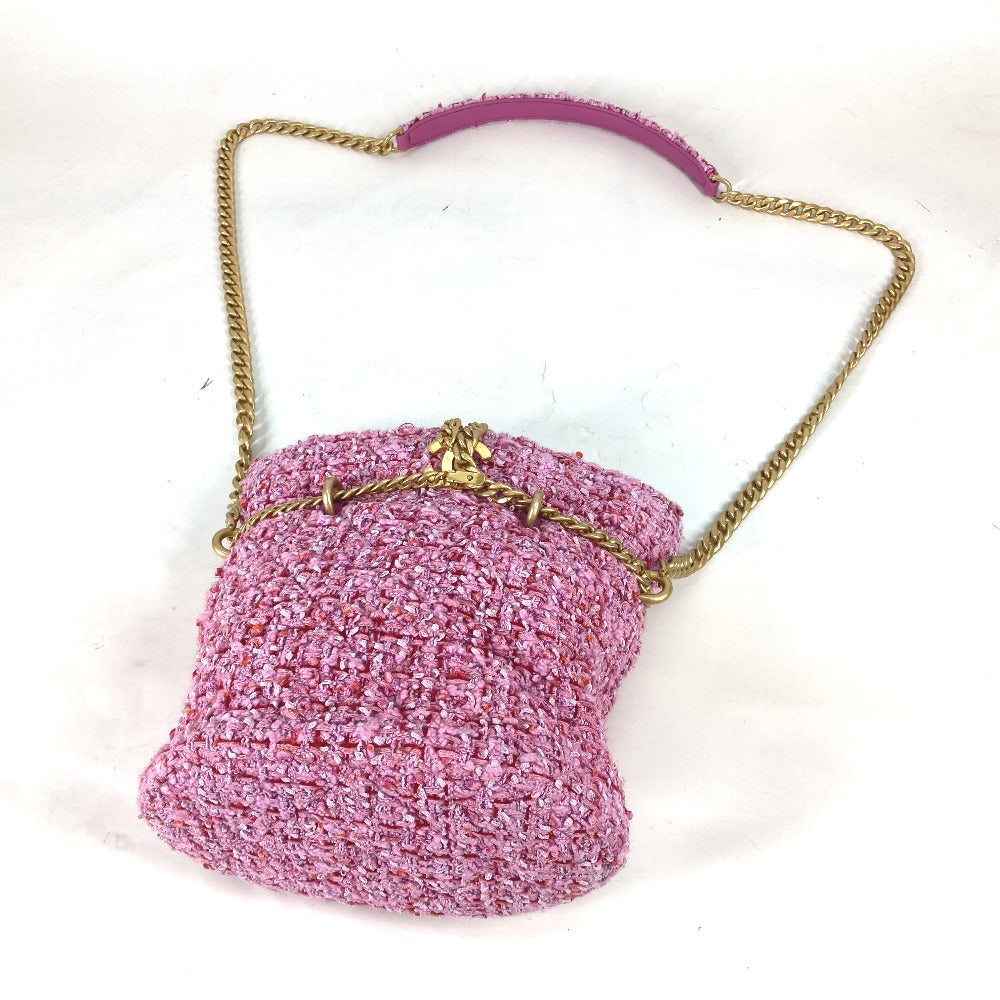 Pink textured handbag with a gold chain handle on a white background