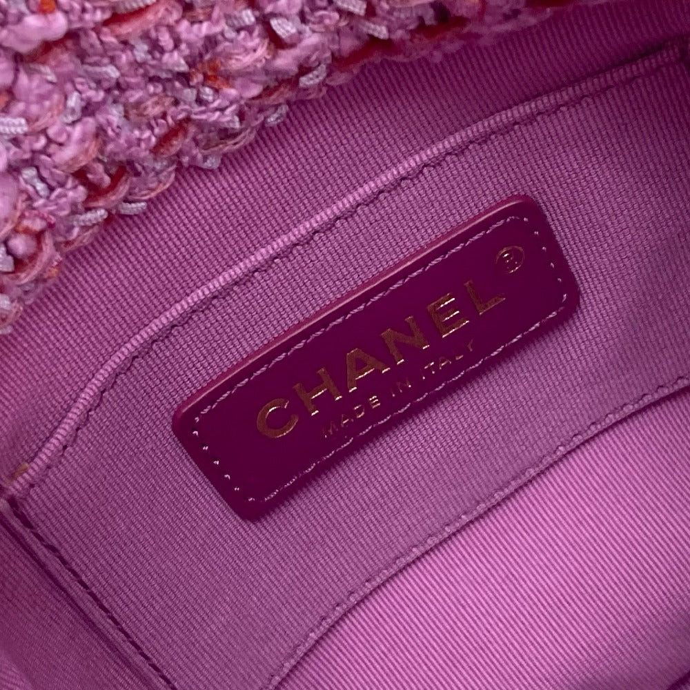 Close-up of a Chanel label on a pink textured fabric background