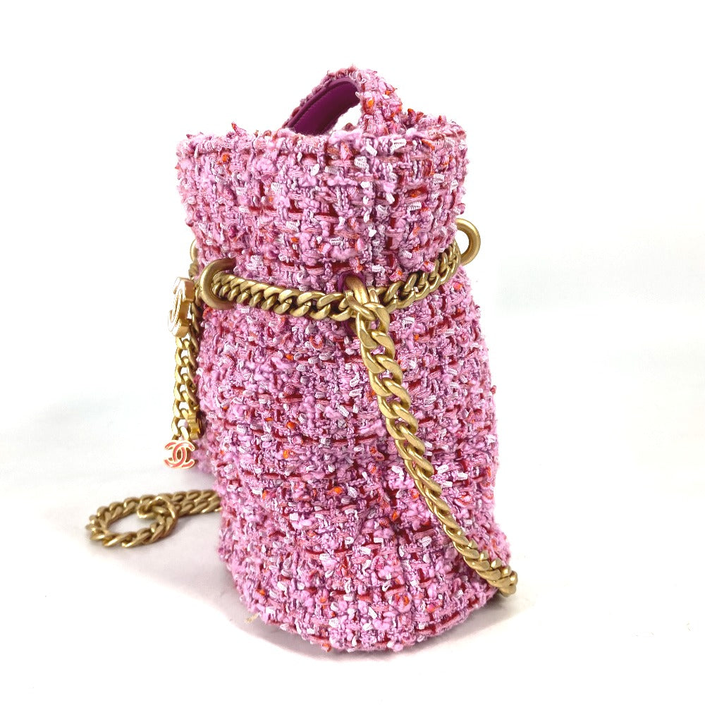Pink textured handbag with a gold chain on a white background