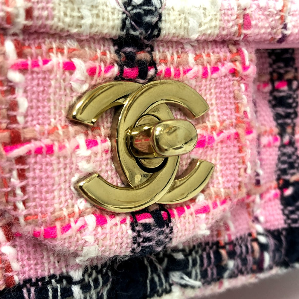 Gold Chanel logo on a textured fabric background