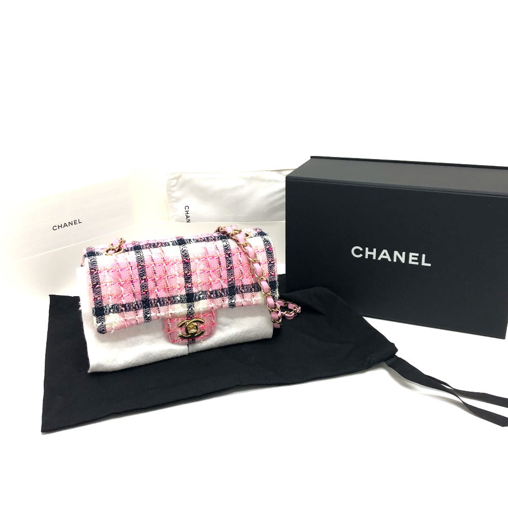 Chanel handbag with checkered pattern in a box on a white background