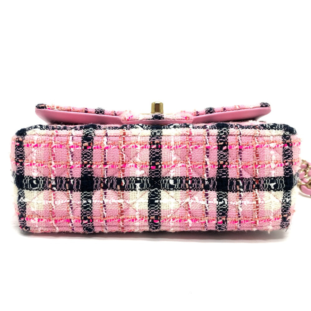 Pink and black checkered clutch bag on a white background