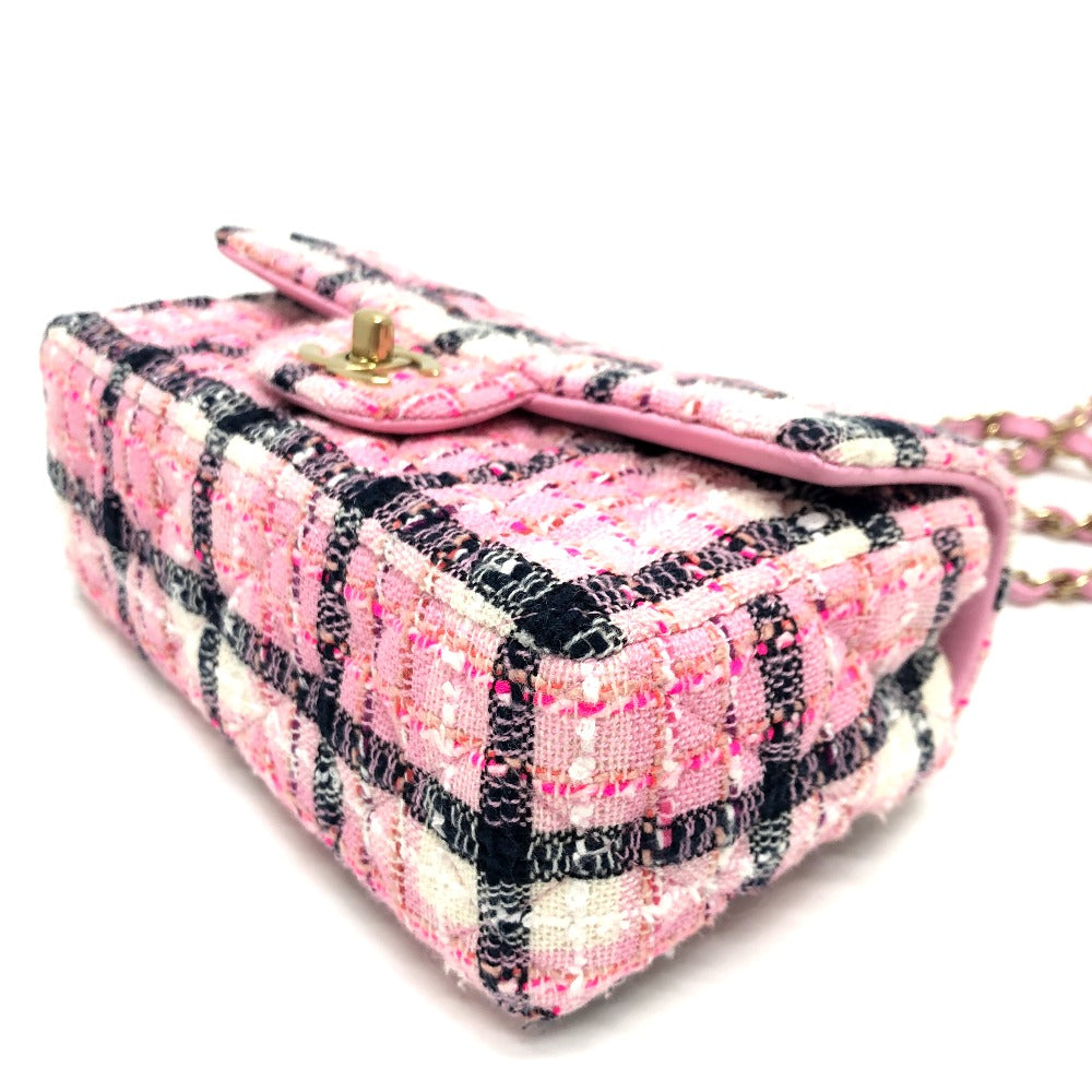 Pink and black plaid handbag with a chain strap on a white background