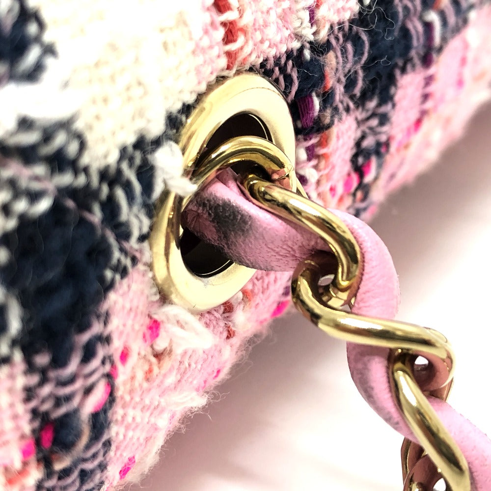 Close-up of a pink textured bag with gold chain detail
