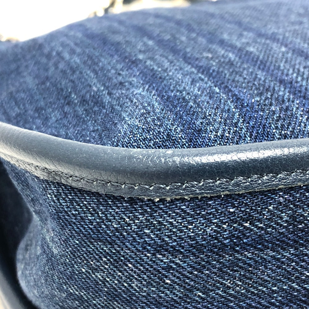 Close-up of blue denim fabric with a leather trim