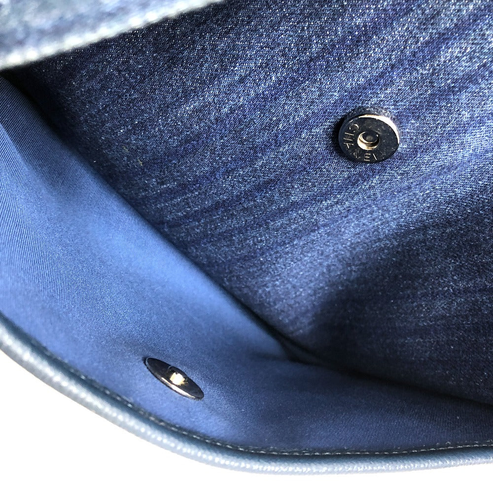Close-up of a blue denim fabric with metal buttons on a white background