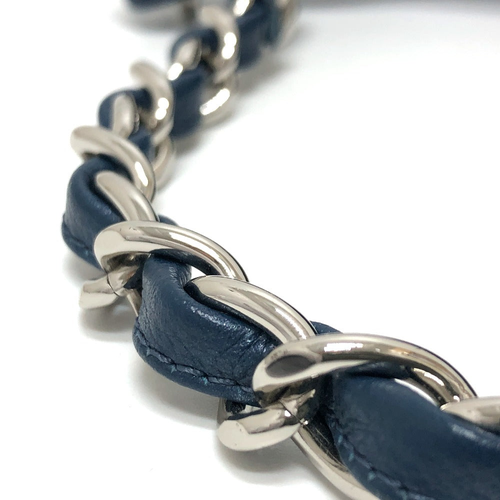 Close-up of a blue leather and silver chain bracelet on a white background