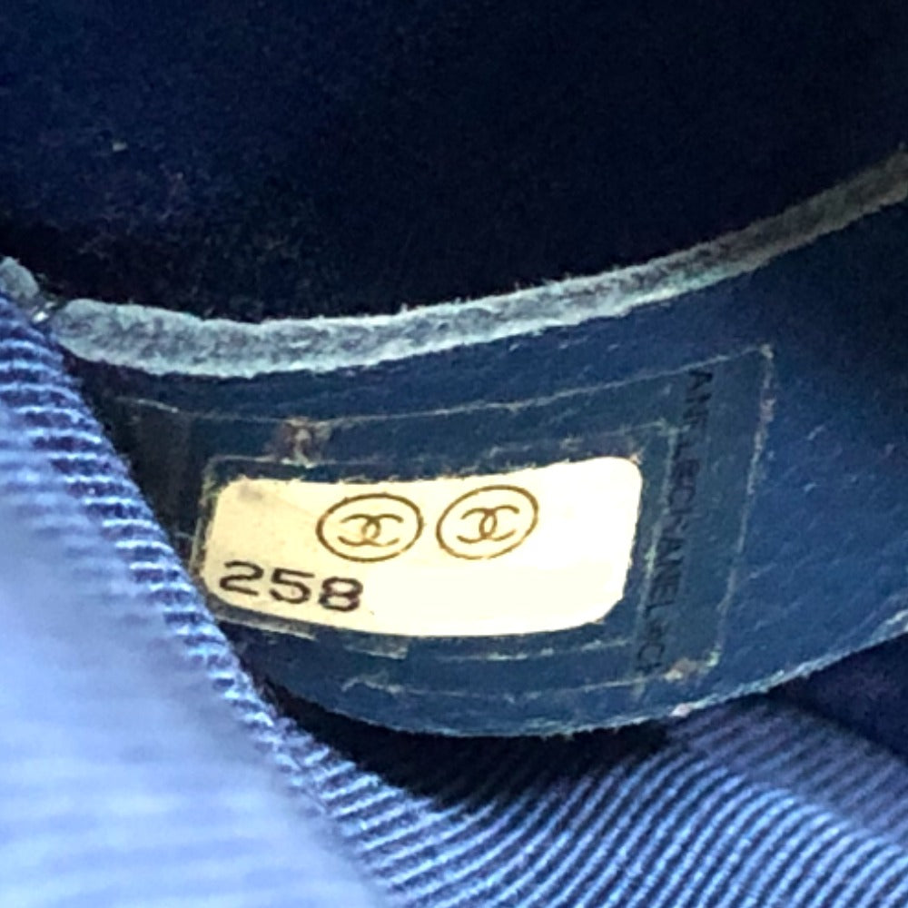 Close-up of a Chanel label on a blue garment with '258' printed on it.