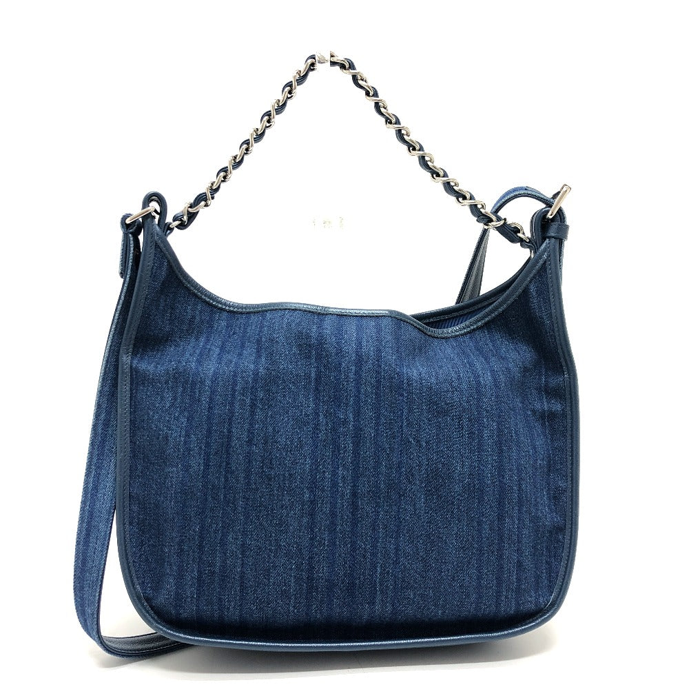 Blue denim handbag with a chain shoulder strap on a white background