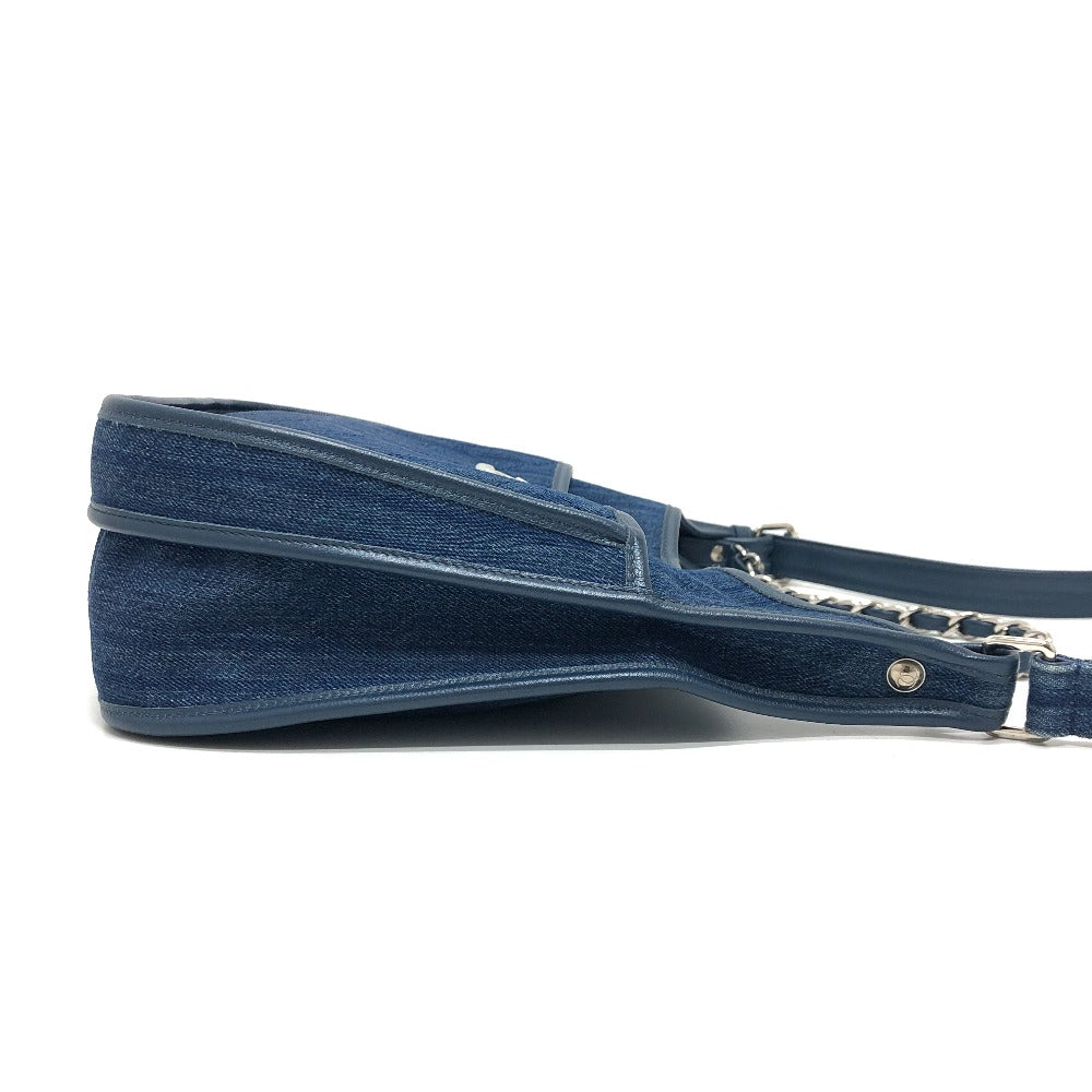 Blue denim handbag with a strap on a white background