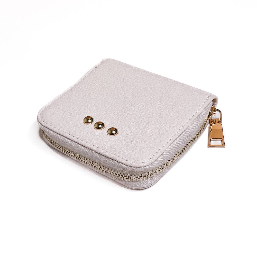 Small white zippered purse with gold accents on a white background