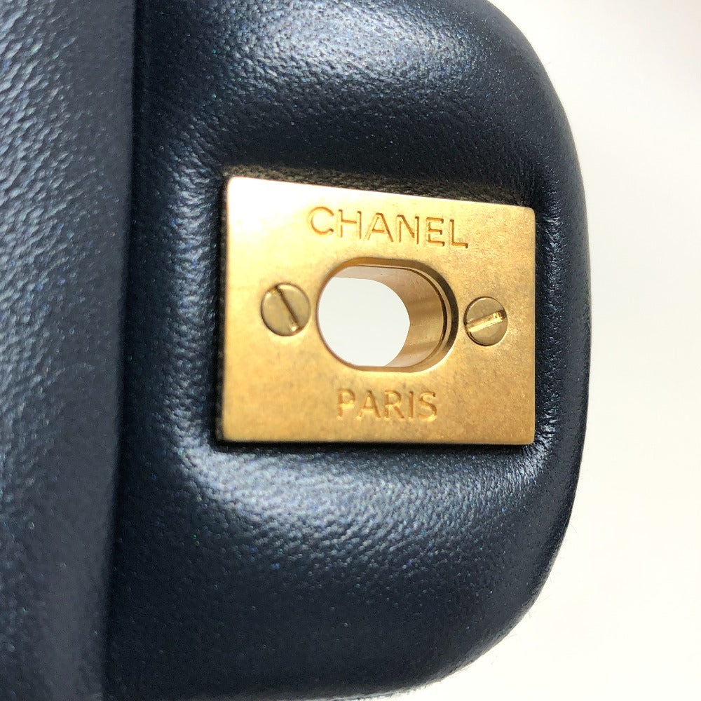 Close-up of a Chanel logo on a black leather product.