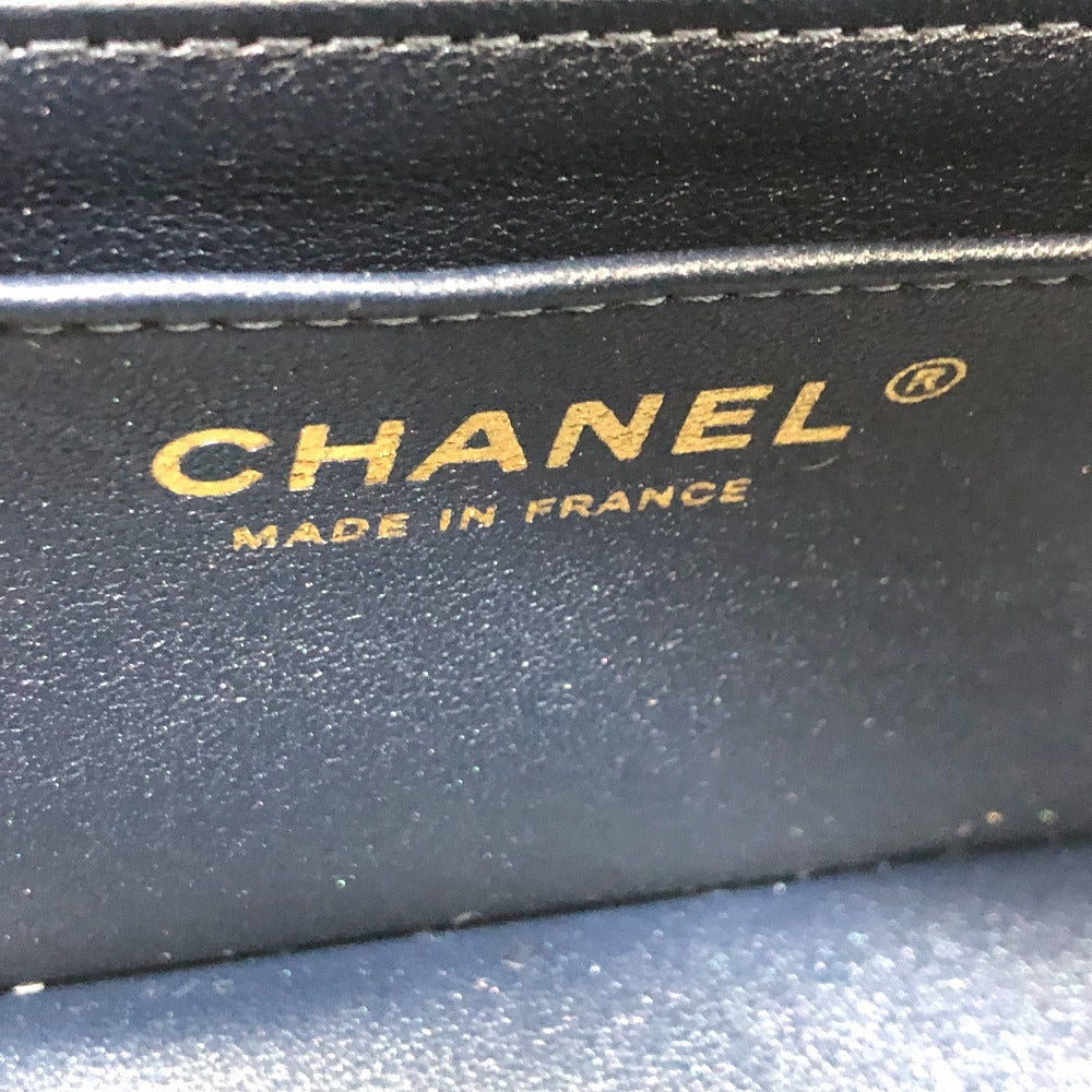 Close-up of a Chanel wallet with 'Made in France' text on a blue background